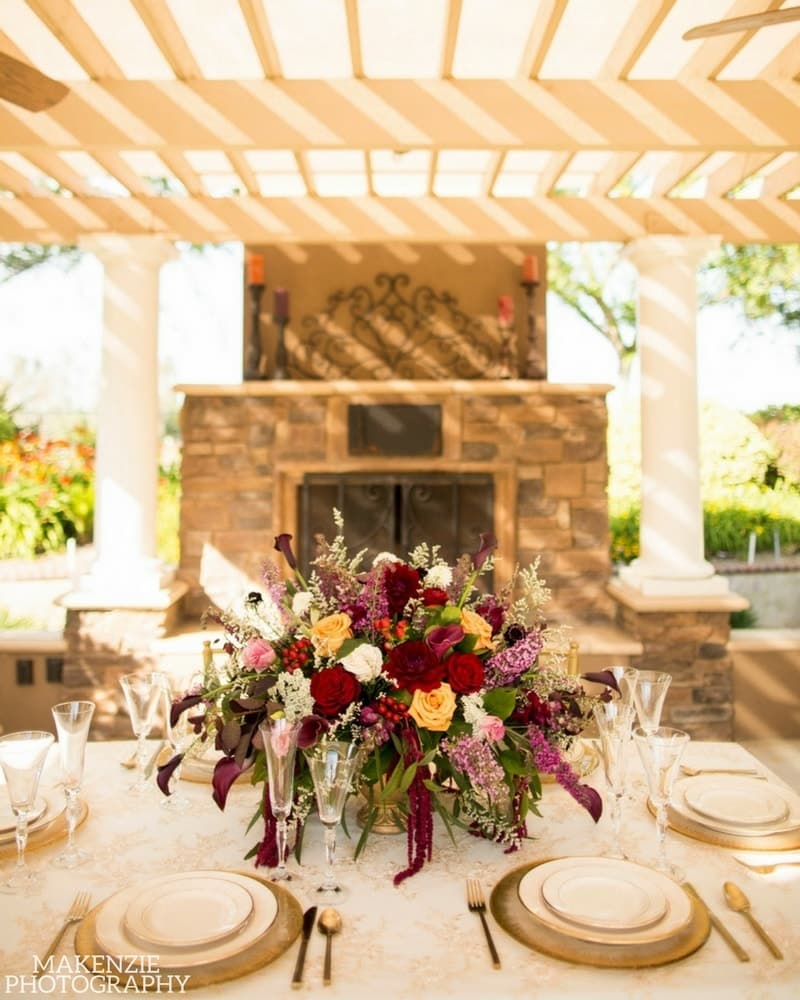 Floral reception table beneath the ranch gazebo